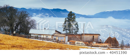 Wooden old house in the mountains in a foggy weather Wooden old house in the mountains in a foggy weather 40451390