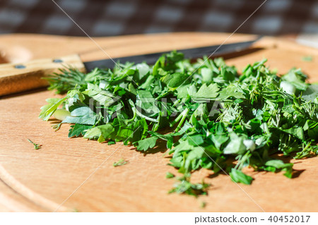Chopped greens with knife on cutting board Chopped greens with knife on cutting board 40452017