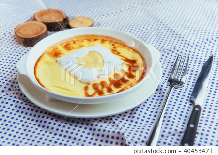 Delicious cheese casserole in a ceramic pot. Delicious cheese casserole in a ceramic pot. 40453471
