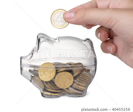 Close up of hand putting coin into piggy bank 40455259