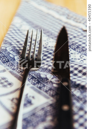 knife and fork at napkin on wooden background knife and fork at napkin on wooden background 40455390