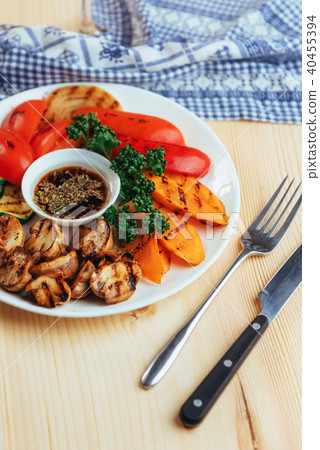 grilled vegetables with sauce on a wooden background grilled vegetables with sauce on a wooden background 40455394