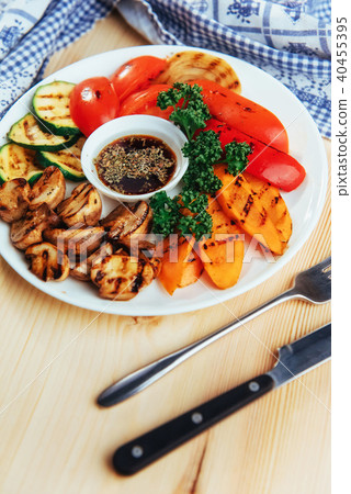 grilled vegetables with sauce on a wooden background grilled vegetables with sauce on a wooden background 40455395