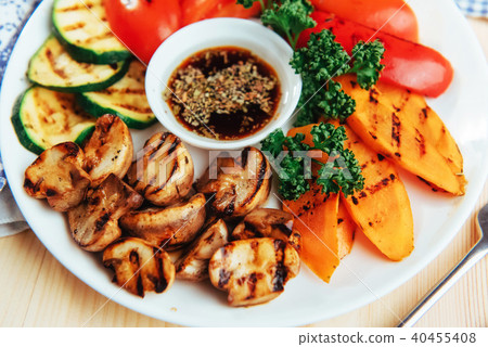 grilled vegetables with sauce on a wooden background grilled vegetables with sauce on a wooden background 40455408