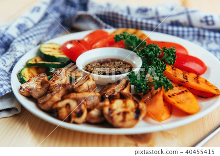 grilled vegetables with sauce on a wooden background grilled vegetables with sauce on a wooden background 40455415