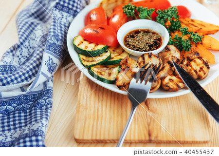 grilled vegetables with sauce on a wooden background 40455437
