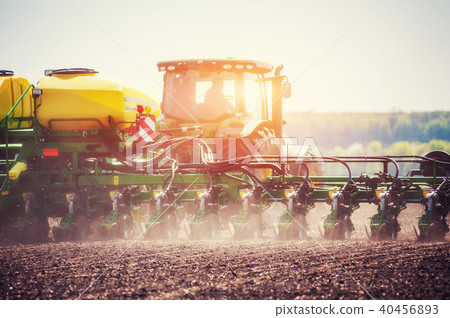 Tractor plowing farm field in preparation for spring planting Tractor plowing farm field in preparation for spring planting 40456893