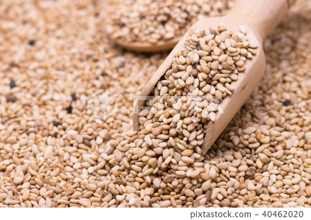 white sesame in wooden spoon on sesame background. white sesame in wooden spoon on sesame background. 40462020