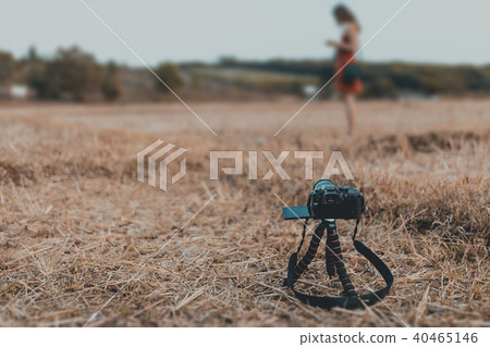 Dslr camera standing on tripod at the rice filed. Dslr camera standing on tripod at the rice filed. 40465146
