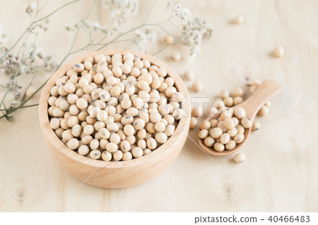 Soybeans in wooden cup and wooden spoon on wood 40466483