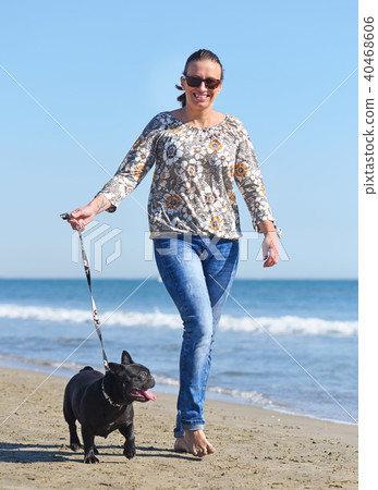 woman and dog on the beach woman and dog on the beach 40468606