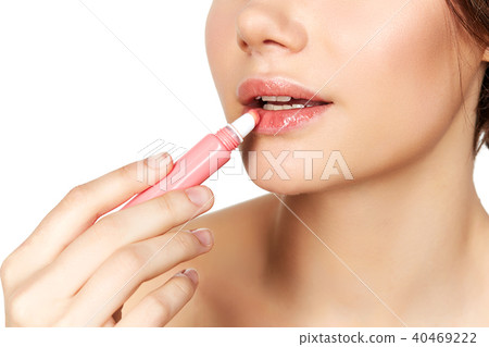 girl applying lipgloss girl applying lipgloss 40469222
