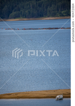 Waters of the lake, sand and lonely fishing boat Waters of the lake, sand and lonely fishing boat 40472884