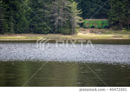 Old rusty bus storage at mountain lake 40472891