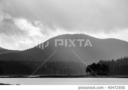 Small island with layered mountain background Small island with layered mountain background 40472898
