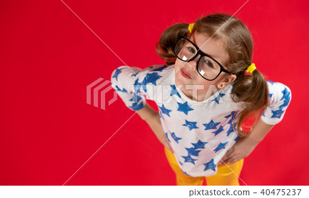 funny child girl in glasses on colored background 40475237