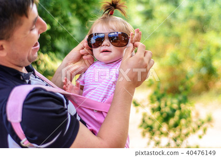 Amazing little girl is playing with sunglasses with her father 40476149