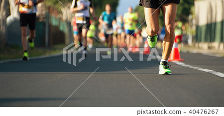 Marathon running race, people feet on city road 40476267