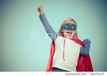 Funny little girl playing power super hero. Funny little girl playing power super hero. 40479135