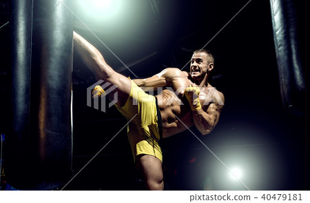Thai boxer punch kick by punching bag 40479181