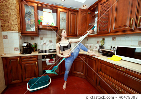Woman jokes about the mop. Woman jokes about the mop. 40479398