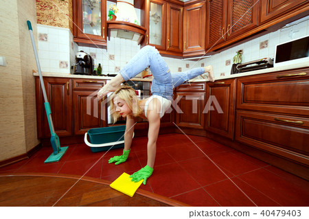 Acrobat woman is cleaning an apartment. Acrobat woman is cleaning an apartment. 40479403