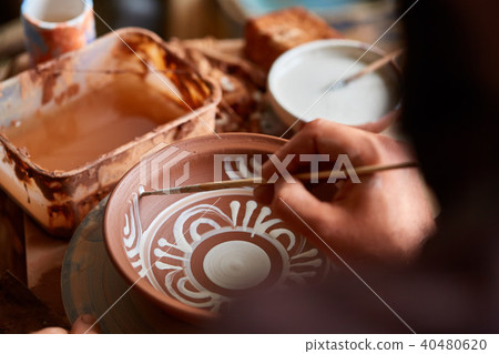 Scary face alike handmade potter mug on a wooden shelf, close-up, shellow depth of field. Scary face alike handmade potter mug on a wooden shelf, close-up, shellow depth of field. 40480620