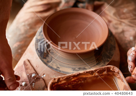 Making pottery on a potter's wheel in the workshop, close-up, selective focus. Making pottery on a potter's wheel in the workshop, close-up, selective focus. 40480643
