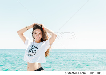 Relaxed woman enjoying sun, freedom and life on beautiful beach in sunshine. Concept of vacations. 40481049