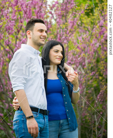 Happy girl and her boyfriend having walk in park Happy girl and her boyfriend having walk in park 40482127