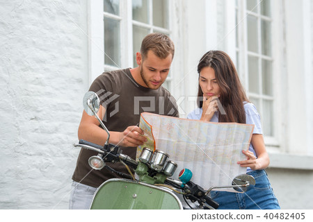Image of young happy loving couple holding map 40482405