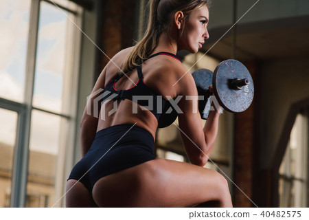 Woman with dumbbell back view 40482575