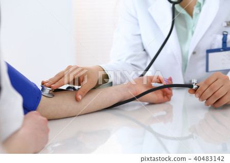 Doctor checking blood pressure of the patient, closeup. Cardiology in medicine  and health car 40483142