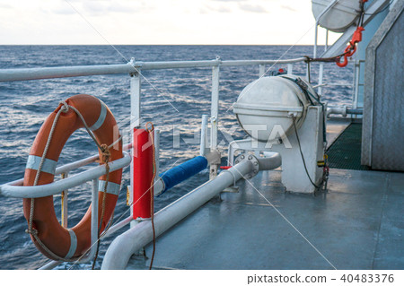 View of ocean from ship or vessel. LSA life saving equipment is on deck 40483376