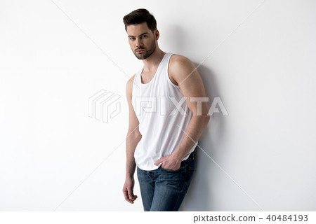 Attractive guy is standing thoughtfully Attractive guy is standing thoughtfully 40484193