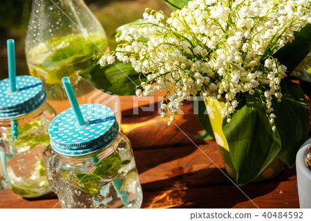 two glasses full of delicious lemonade on a picnic table 40484592