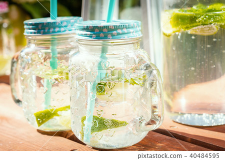 two glasses full of delicious lemonade on a picnic table two glasses full of delicious lemonade on a picnic table 40484595