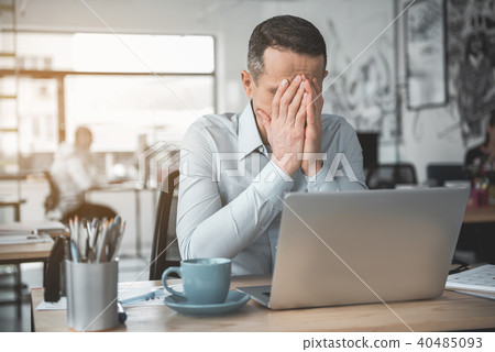 Worried businessman locating at desk 40485093