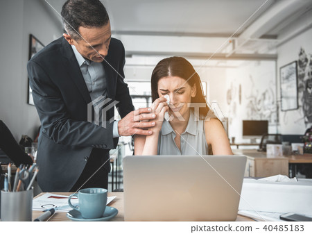 Serene businessman talking with crying lady 40485183