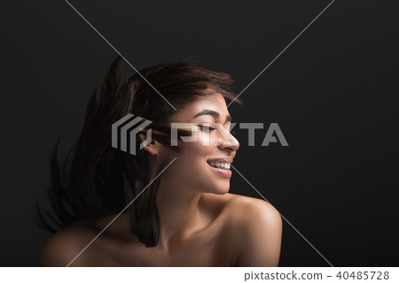 Beautiful woman rejoicing in healthy hair 40485728