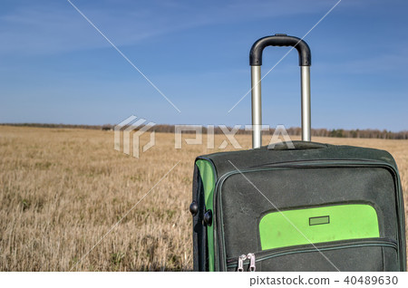 Green roll-aboard suitcase on a 40489630