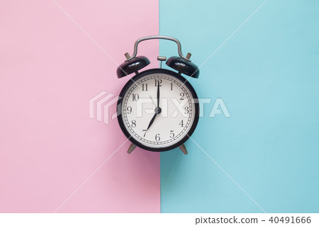 Close up clock on pink and blue background 40491666