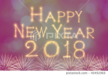 Happy new year 2018 written with Sparkle firework on fireworks with dark background, celebration and greeting cards concept Happy new year 2018 written with Sparkle firework on fireworks with dark background, celebration and greeting cards concept 40492968