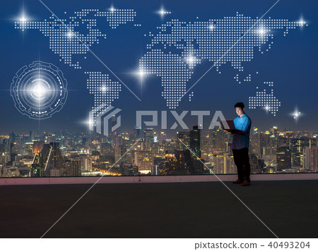 Asian technician engineer standing and using the laptop with Network graphic over the world map dot and cityscape background at night time, Business success and technology concept Asian technician engineer standing and using the laptop with Network graphic over the world map dot and cityscape background at night time, Business success and technology concept 40493204