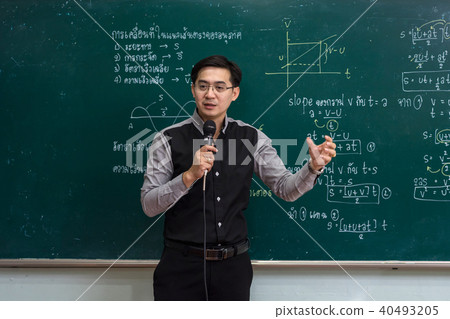 Asian teacher Giving Lesson over the the physics formular in thai laguage on black board in school classroom, school education concept, The teacher wrote himself 40493205
