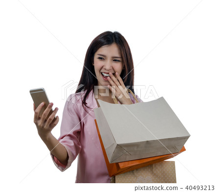 Happy young asian woman shopping in happy feeling and holding the product paper bag on white background, include clipping path 40493213