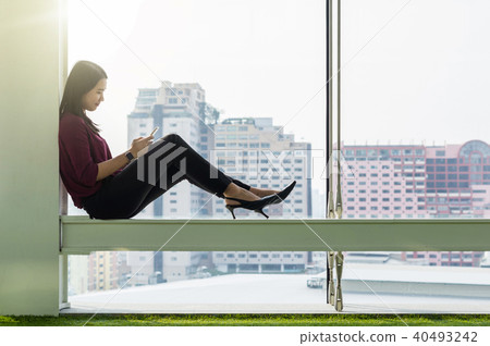 Businesswomen using the smart phone In the modern creative Office, business success concept Businesswomen using the smart phone In the modern creative Office, business success concept 40493242