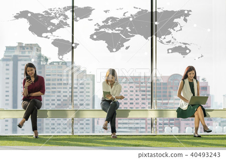 three women using social network each technology equipment In the modern creative Office beside the windows at the evening, business social network concept three women using social network each technology equipment In the modern creative Office beside the windows at the evening, business social network concept 40493243