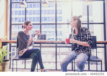 Hipster young couple freelancer talking and working with smile action in the Loft cafe workplace. Creative Startup and entrepreneur business concept Hipster young couple freelancer talking and working with smile action in the Loft cafe workplace. Creative Startup and entrepreneur business concept 40493291