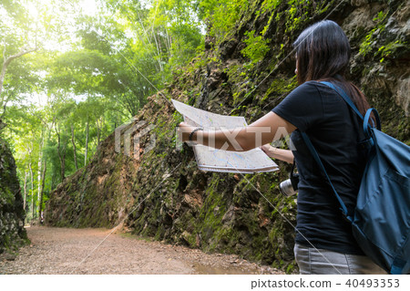 Back side of young traveler see the map in the deep forest, Hellfire Pass at kanchanaburi, Thailand, Travel and transportation concept 40493353